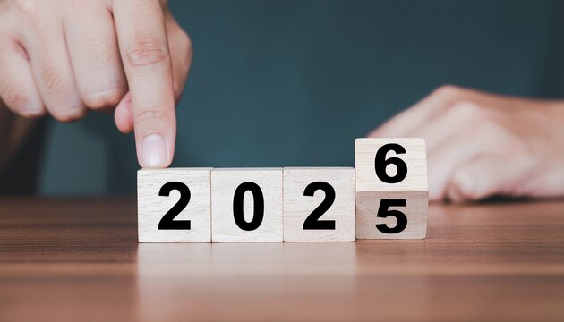 Exciting 2026 new year is coming! Person setting up wooden blocks with 2026 on a table, anticipating fresh starts and opportunities for growth
