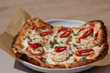 Close-up of a pizza with tomatoes and paprika.