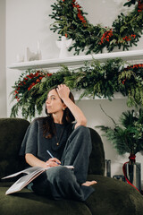 Fototapeta premium Woman writing in journal during holiday season