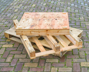 wooden industrial pallets stacked on top of each other outside on the street