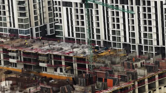 Sideways right drone movement with rotating camera over active construction site
