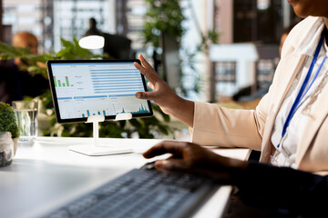 African american business associates reviewing data analytics and performance metrics in a modern office, creating a new strategy for growth and expansion. Decision making between team members.