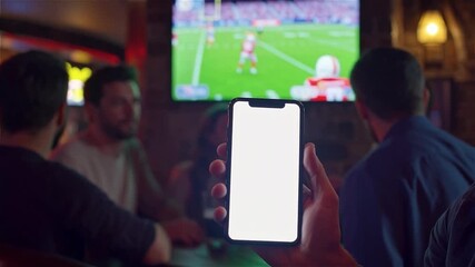 Watching Sports on Phone - Friends at Bar, Mobile Device Displaying Football Game.

 - Powered by Adobe