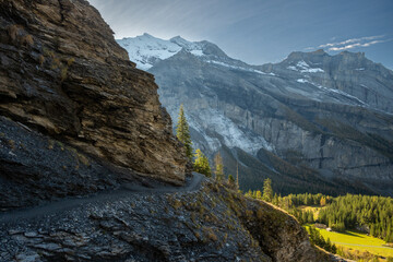 Trail Takes A Winding Curve Around A Rock Outcropping Over Oeschinen Lake