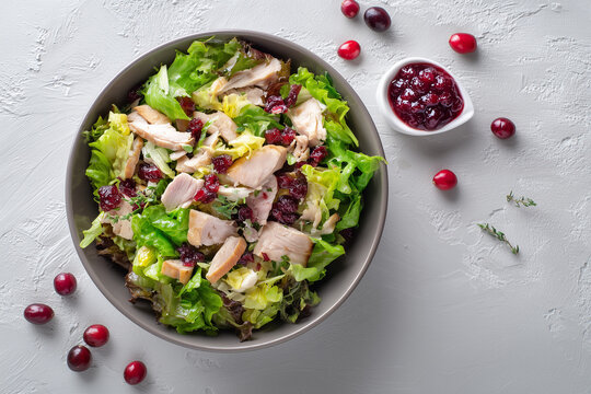 Bright salad made from Christmas leftovers, featuring tender chicken, fresh greens, and seasonal flavors arranged in a clean, appetizing presentation.