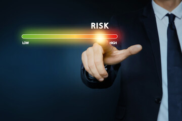 Man regulating level of risk on virtual screen against dark background, closeup