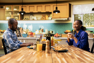 African american couple planning grocery orders online using a laptop. Boyfriend and girlfriend...
