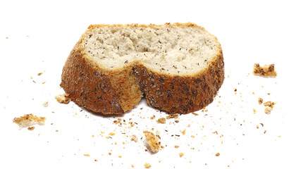 Fresh baked, slice of integral buckwheat bread with crumbs isolated on white