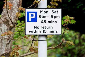 Public parking sign on land with parking restrictions