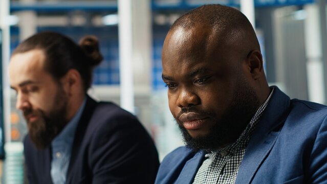 Engineers in factory office using laptop to collect performance data to refine designs for increased energy output. Photovoltaics plant experts design innovative solar cell prototypes, camera B