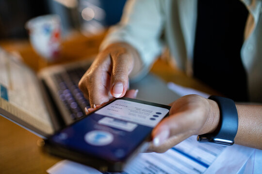 Adult focused on mobile payment with credit card at home