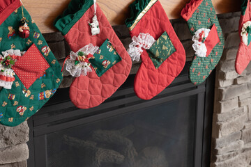 Christmas stockings hung on a fireplace mantle close up