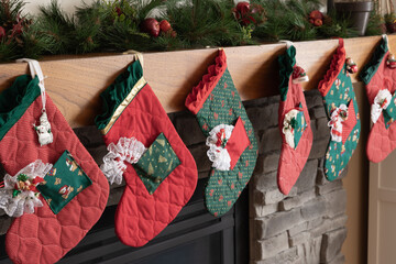 Christmas stockings hung on a mantle of a fireplace