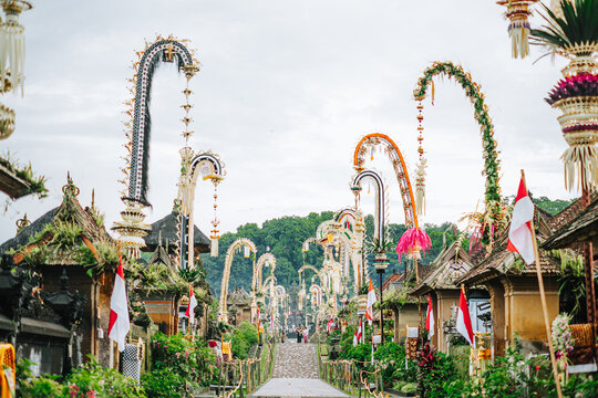 Balinese street in Penglipuran Village with Penjor poles