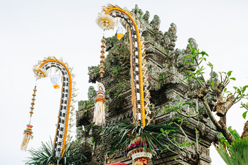 Balinese Penjor poles and ornate temple architecture