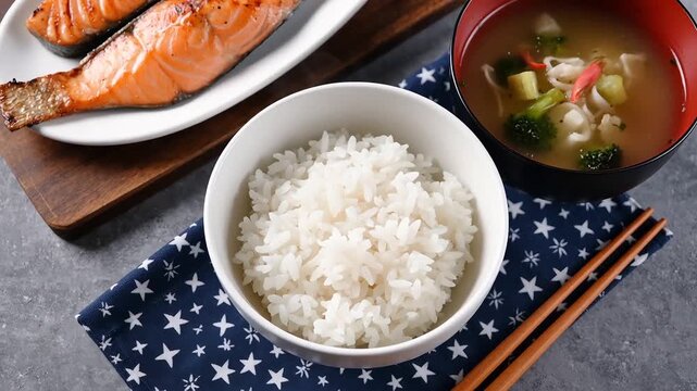 Healthy traditional japanese meal with grilled salmon steamed white rice and warm miso soup top view