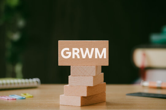 There is wood block with the word GRWM. It is an abbreviation for Get Ready With Me as eye-catching image.