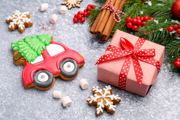 Tasty gingerbread cookies and Christmas decor on light grey table, closeup