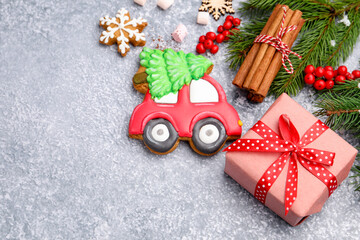 Tasty gingerbread cookies and Christmas decor on light grey table, above view. Space for text