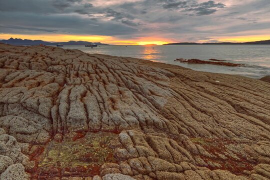 The colorful sundown paints in a reddish hue the Elgol village rocky beach and bay on Loch Scavaig, Strathaird peninsula. Isle of Skye-Scotland-097