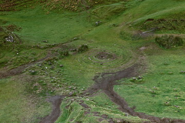 Stone-dotted spiral cut into the grass, Fairy Glen or Balnaknock, seen from atop the natural basalt outcrop of Castle Ewen. Isle of Skye-Scotland-121