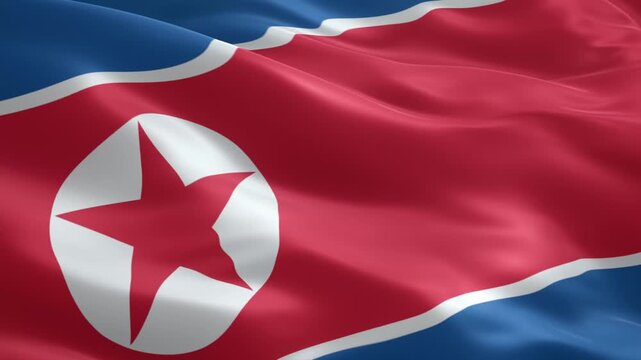 Waving flag of democratic people's republic of korea (dprk), featuring a bold red star on a white circle, bordered by blue and white stripes, symbolizing national pride and sovereignty.