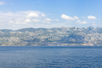 Beautiful mountains surrounded by the sea. blue sea and mountains in the distance in summer