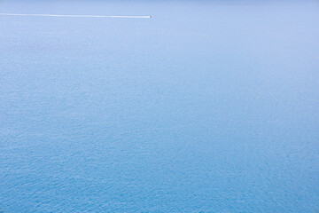 Blue sea water surface texture with ripples, splashes