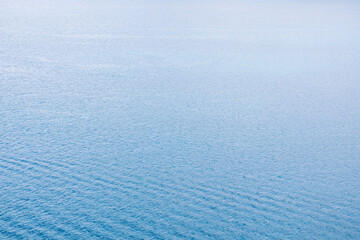 Blue sea water surface texture with ripples, splashes