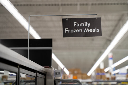 Close up of family frozen meals aisle sign in supermarket.