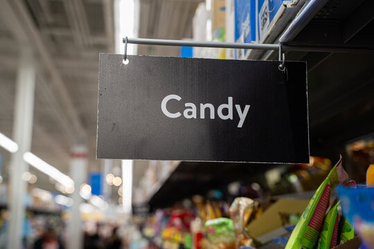 Close up of candy aisle sign in supermarket.