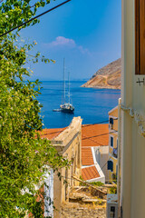 Landscape view on the sea over the roofs from the hill, Symi town, Greece