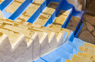 Close up of old stone staircase painted in white and blue, Symi island, Greece