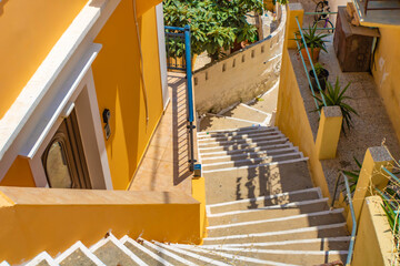 Top view of stone stairs between yellow Symi houses, Symi island, Greece