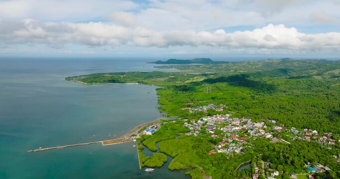 Panorama view of Looc Poblacion with residential area and green forest. Tablas Island. Romblon, Philippines.