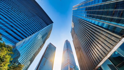looking up at skyscrapers in a modern city with a bright blue sky