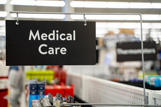 Close up of medical care aisle sign hanging in pharmacy section.