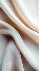 Close-up of a draped fabric with a textured surface. The fabric has a soft, neutral color palette with subtle shadows, illuminated by studio lighting.