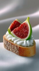 A close-up shot of a crostini topped with cream cheese and sliced figs, set against a white cloth, illuminated by soft lighting.