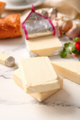 Processed cheese with bread and vegetables on grunge background