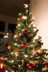  Decorated Christmas Tree with Lights and Ornaments.Festive display case with a decorated tree.Illuminated Christmas Tree with Ornaments and Star