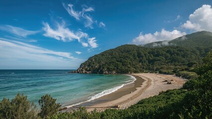 Beach landscape with clear water, lush green mountains, and partly cloudy sky. Nature scene and coastal scenery. The concept of natural environment and scenic landscapes