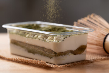 Matcha Tiramisu cake with green tea powder on top, Italian dessert fusion with Japanese