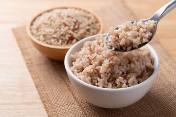 Cooked Thai brown rice in a bowl with spoon, Healthy eating