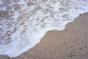 foam on the beach sand. shot with high angle view