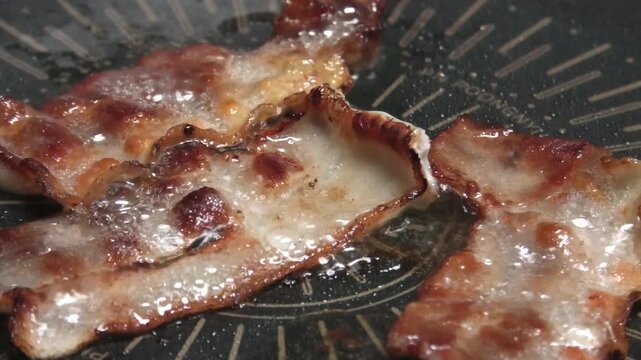Close-up of grilled thin-sliced pork belly at a Korean home.