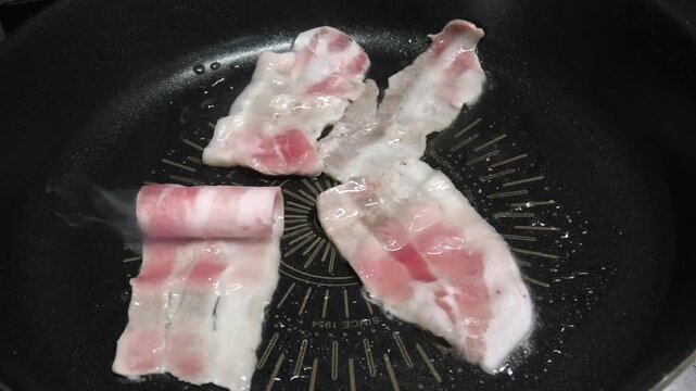 Close-up of grilled thin-sliced pork belly at a Korean home.