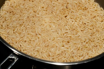 Brown jasmine rice cooking in a steel pot
