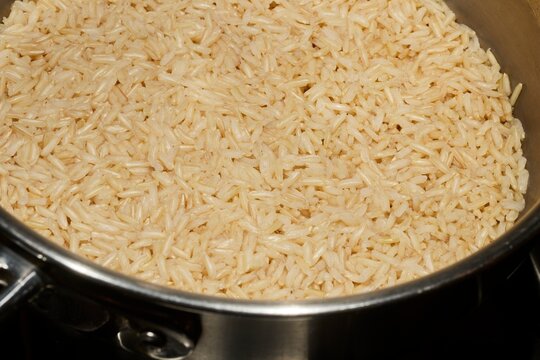 Brown jasmine rice cooking in a steel pot