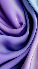 Close-up of elegant, flowing fabric in shades of purple and blue, creating an abstract and artistic background.